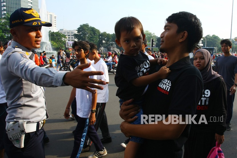 [Ilustrasi] Petugas menghalau warga yang menggunakan atribut bernuansa politik memasuki arena Car Free Day arena tidak sesuai dengan Pergub No.12 tentang larangan melakukan kegiatan politik diacara dan tempat berlangsungnya Hari Bebas Kendaraan Bermotor atau Car Free Day (CFD) di Jakarta, Ahad (6/5).