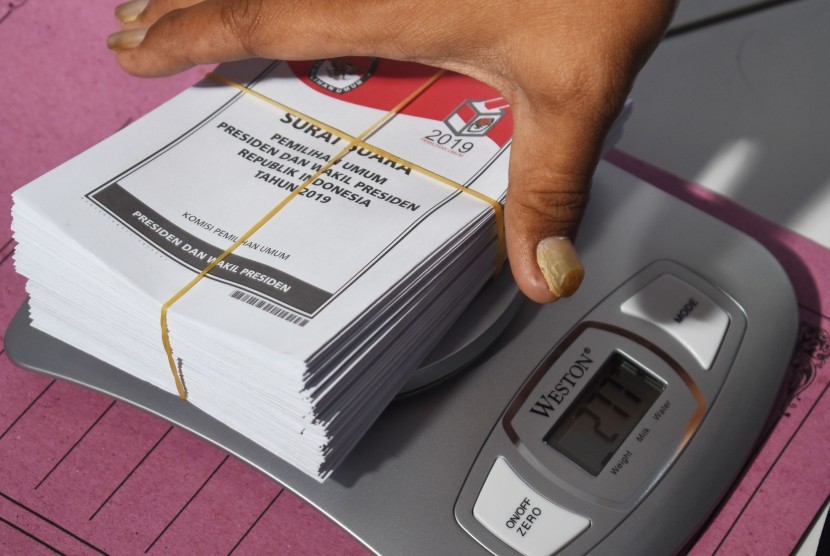 Petugas menimbang surat suara saat penyortiran dan pelipatan surat suara Pemilu 2019 