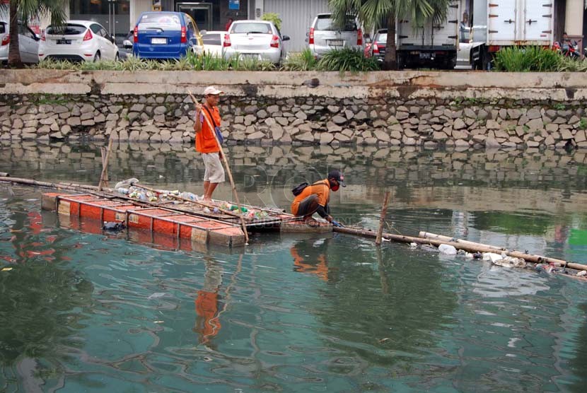   Petugas menjaring sampah di Kali Sunter Jakarta Utara, Jumat (14/3).   (foto :Raisan Al Farisi)