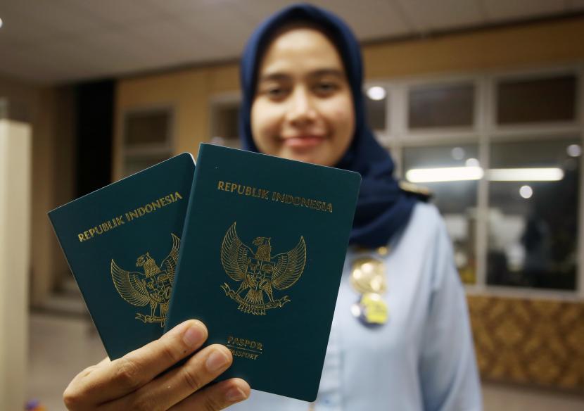 Petugas menunjukan Paspor Republik Indonesia (RI) yang sudah jadi di Kantor Imigrasi Kelas 1 Non TPI Tangerang, Tangerang, Banten, Rabu (5/10/2022). Kementerian Hukum dan Hak Asasi Manusia (Kemenkumham) melalui Direktorat Jendral Imigrasi memberlakukan aturan baru masa berlaku Paspor RI menjadi 10 tahun dari sebelumnya hanya 5 tahun, yang tertuang dalam Pasal 2A Permenkumham RI Nomer 18 tahun 2022 yang diundangkan pada, Kamis (29/9/2022). 