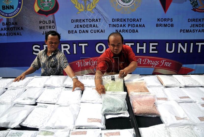  Petugas menunjukan ribuan barang bukti ekstasi yang berhasil disita di halaman Gedung Direktorat Tindak Pidana Narkoba Bareskrim Polri, Cawang, Jakarta Timur, Jumat (15/3).  (Republika/Prayogi)
