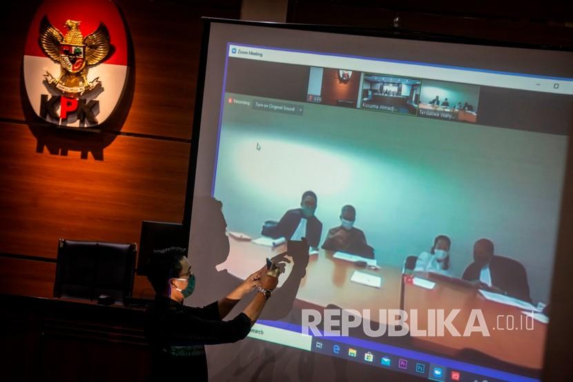 Petugas merekam sidang dakwaan kasus dugaan korupsi penetapan pergantian antar waktu (PAW) anggota DPR periode 2019-2024 secara virtual dengan terdakwa mantan Komisioner Bawaslu Wahyu Setiawan (ketiga kanan) dan mantan anggota Bawaslu Agustiani Tio Fridelina (kedua kanan) di Gedung KPK, Jakarta, Kamis (28/5/2020). Mantan anggota Komisi Pemilihan Umum Wahyu Setiawan didakwa telah menerima suap melalui perantaraan Agustiani Tio Fridelina sebesar Rp600 juta dari Saeful Bahri dan Harun Masiku agar KPU menyetujui permohonan Penggantian Antar Waktu (PAW) yang diajukan PDIP.