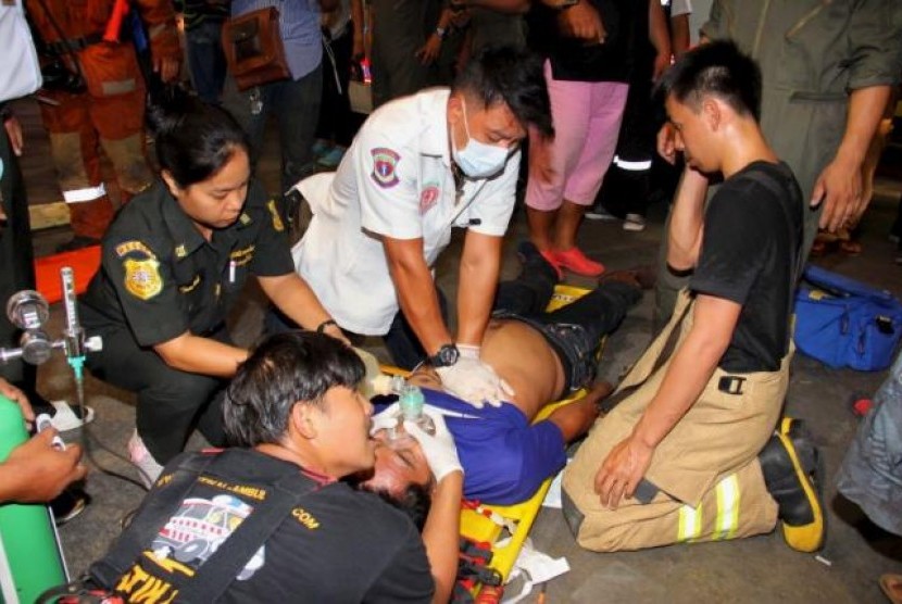 Petugas penyelamat menolong korban kecelakaan kimia di Bank Siam, Bangkok, Thailand, Ahad, 13 Maret 2016.