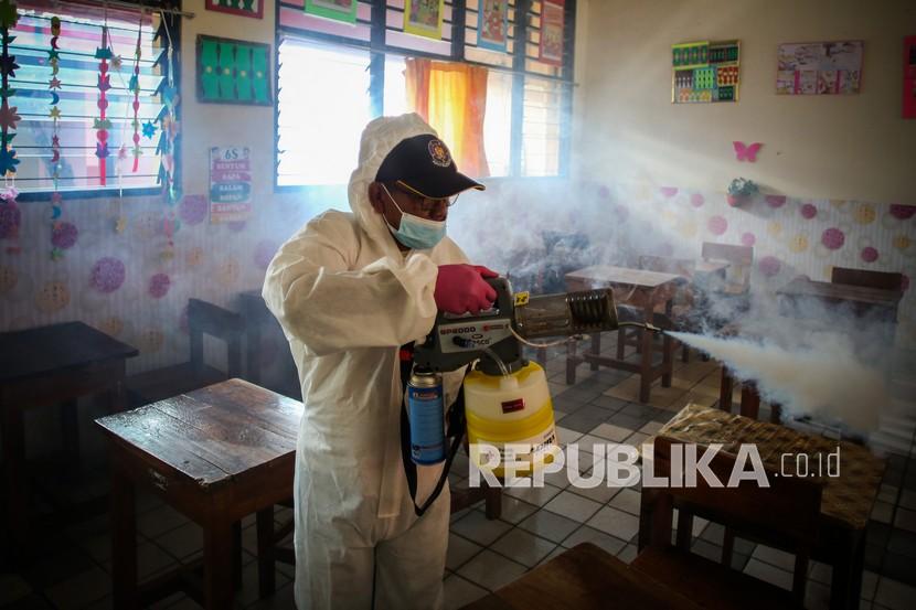 Petugas PMI Jakarta Pusat menyemprotkan cairan disinfektan di SDN Johar Baru 03. Jakarta, Sabtu (22/1/2022). Satgas Covid-19 hari ini mengumumkan dua kasus kematian pasien varian Omicron. 