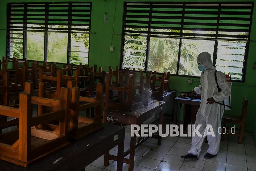 Petugas PMI Jakarta Pusat menyemprotkan cairan disinfektan di SMPN 4, Jakarta, Jumat (4/2/2022). Penyemprotan disinfektan di lingkungan sekolah sebagai upaya mencegah penyebaran COVID-19.