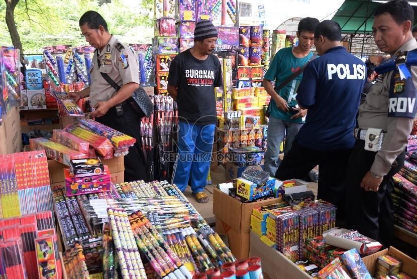 Petugas polisi Polsek Taman Sari merazia kembang api dan petasan di Pasar Asemka, Jakarta, Selasa (29/12).  (Republika/Yasin Habibi)