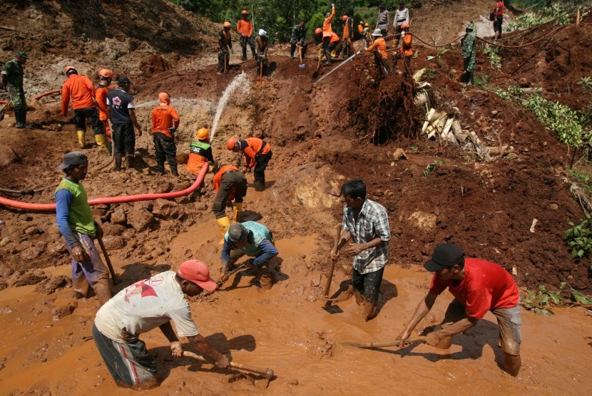 Petugas SAR gabungan bersama relawan dan warga mencari korban bencana longsor yang tertimbun di Desa Kepel, Nganjuk, Jawa Timur,Rabu (12/4). 