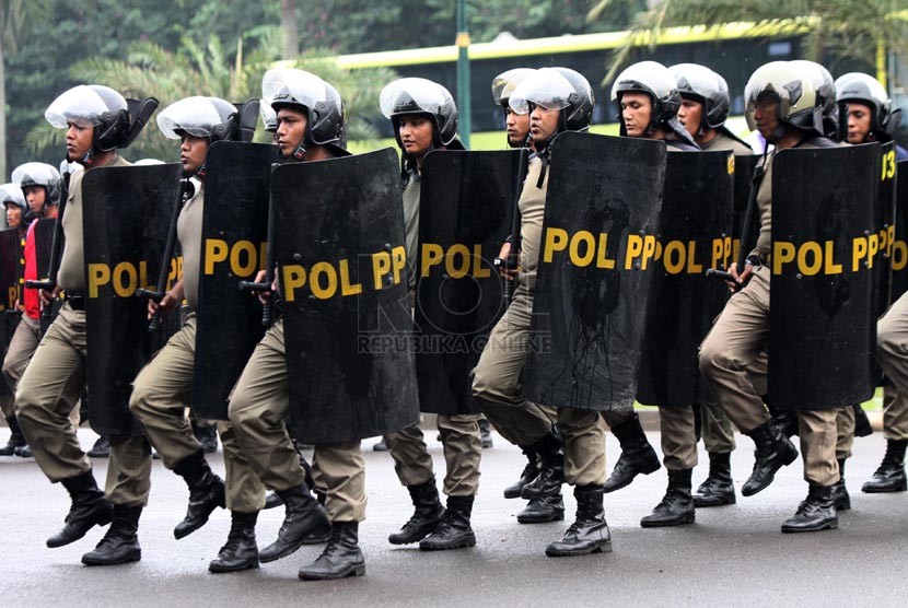 Petugas Satpol PP berlatih baris berbaris di halaman Monumen Nasional (Monas), Jakarta Pusat, Selasa (11/3). (Republika/Yasin Habibi)