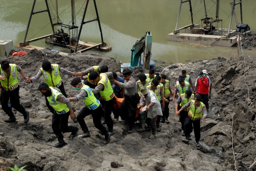 Petugas Tim SAR Gabungan mengevakuasi jenazah, Alun (50), yang tertimbun longsor di lokasi pertambangan pasir Desa Titisan, Kecamatan Sukalarang, Sukabumi, Jawa Barat, Senin (5/9). 