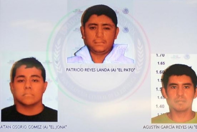 Pictures of the detainees for the case of missing students of Ayotzinapa are seen displayed on a television screen during a news conference at the Attorney General's Office building in Mexico City in this November 7, 2014, handout courtesy of the office.