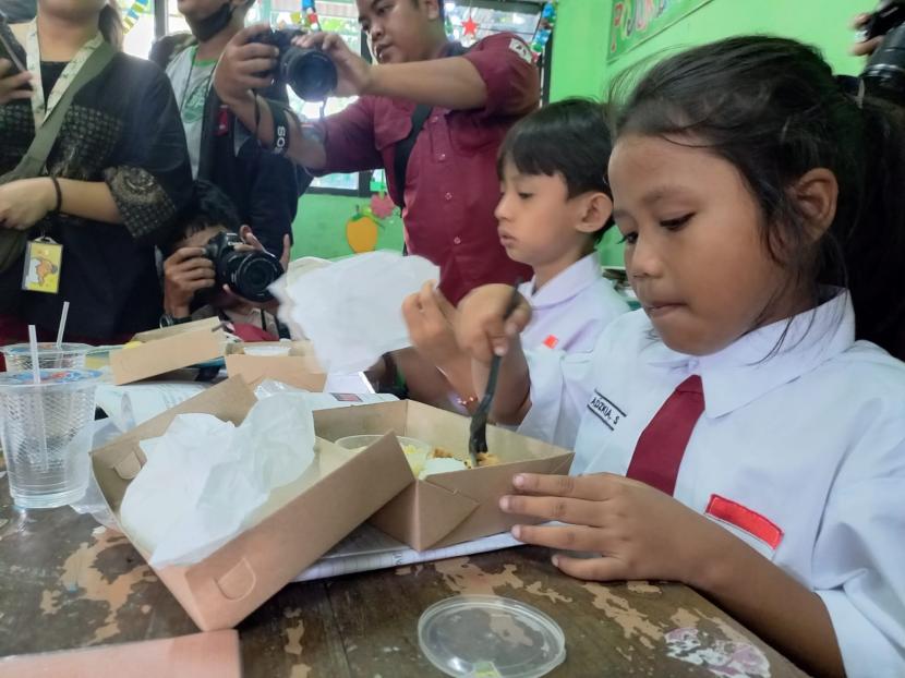 Siswa-siswi berbincang dengan Penjabat (Pj Gubernur DKI Jakarta Heru Budi Hartono saat uji coba makan gratis di SDN Cideng 07, Kelurahan Cideng, Kecamatan Gambir, Jakarta Pusat, Senin (19/8/2024).