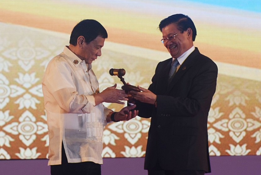 PM Laos Thongloun Sisoulith (kanan) menyerahkan palu kepada Presiden Filipina Rodrigo Duterte dalam penutupan ASEAN Summit di National Convention Center, Vientiane, Laos, Kamis (8/9). 