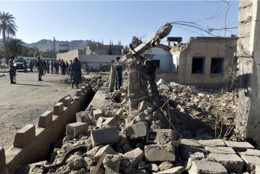  Polisi Afghanistan berdiri di sebuah bangunan yang hancur akibat serangan Taliban. Taliban mengaku bertanggungjawab atas serangan di sebuah pusat militer Afghanistan. Ilustrasi.