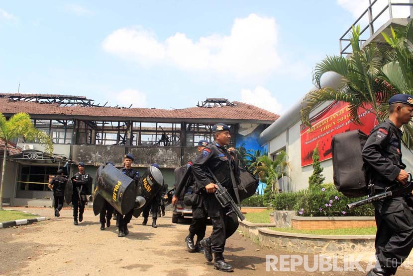 Polisi bersenjata lengkap bersiap melakukan penjagaan ketat pasca kebakaran yang terjadi di Lembaga Pemasyarakatan Kelas IIA Banceuy, Kota Bandung, Ahad (24/4). (Republika/Dede Lukman Hakim)