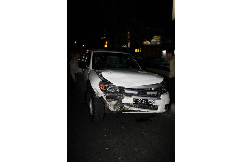 Polisi dan warga menyaksikan mobil yang mengalami kecelakaan di pinggir Jalan Raya (ilustrasi).