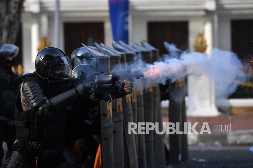 Polisi menembakkan gas air mata ke arah pengunjuk rasa saat demo menolak Undang-undang Cipta Kerja di depan Gedung Negara Grahadi, Surabaya, Jawa Timur, Kamis (8/10/2020). Aksi yang dikuti ribuan orang dari berbagai elemen mahasiswa dan buruh tersebut berakhir ricuh dan mengakibatkan sejumlah fasilitas umum rusak. 