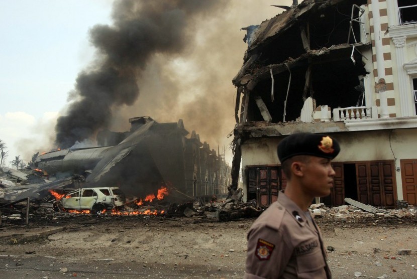  Polisi mengamankan lokasi jatuhnya pesawat Hercules C-130 TNI AU di Medan, Selasa (30/6). (EPA/Dedi Sahputra)