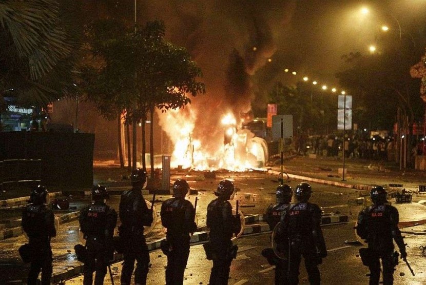 Polisi siaga di lokasi kerusuhan di kawasan Little India, Singapura, pada Ahad (8/12/2013)