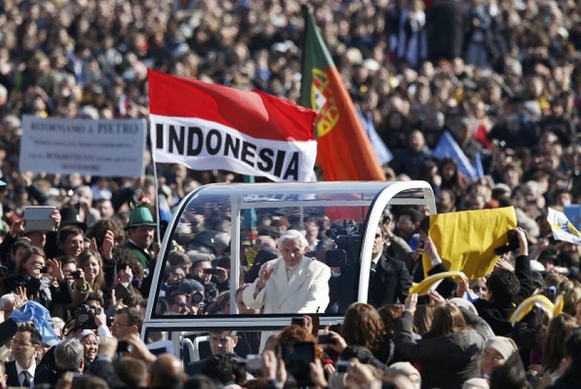 Pope Benedict XVI waves to the faithful as he arrives in St Peter's Square to hold his last general audience at the Vatican February 27, 2013. 