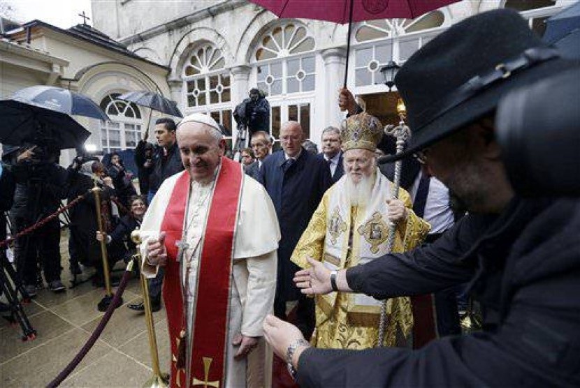Pope Francis, left, and Ecumenical Patriarch Bartholomew I leave the Patriarchal Church of St. George after a holy liturgy in Istanbul, Sunday, Nov. 30, 2014. 