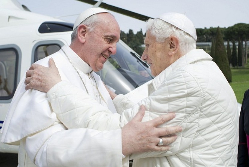 Pope Francis (left) embraces Pope Emeritus Benedict XVI as he arrives at the Castel Gandolfo summer residence March 23, 2013. 