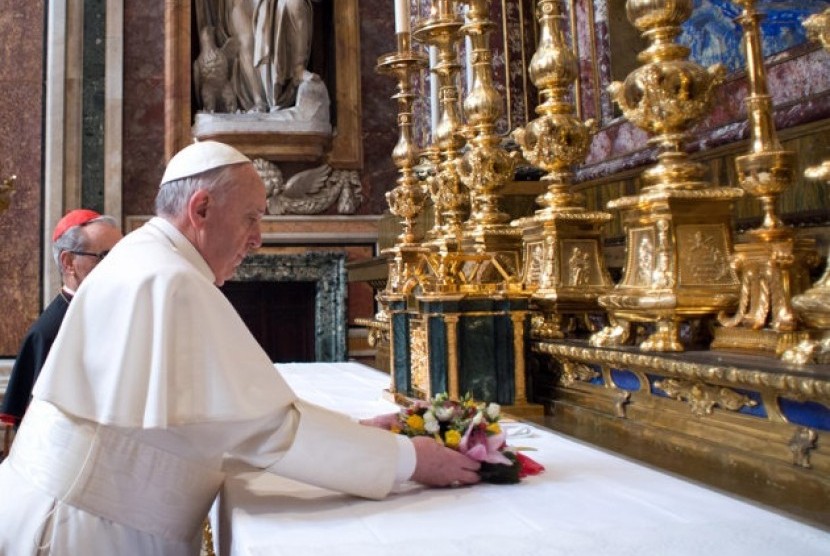 Pope Francis puts flowers on the altar inside St. Mary Major Basilica, in Rome, Thursday, March 14, 2013. 