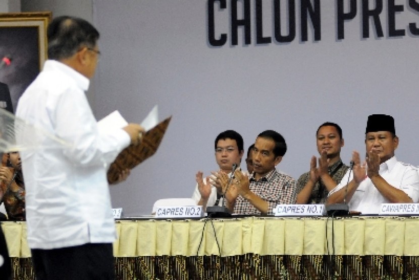 Prabowo Subianto (kanan) dan Joko Widodo (ketiga kanan) memberi tepuk tangan usai Jusuf Kalla membacakan laporan harta kekayaan di Kantor KPU, Jakarta, Selasa (1/7). 