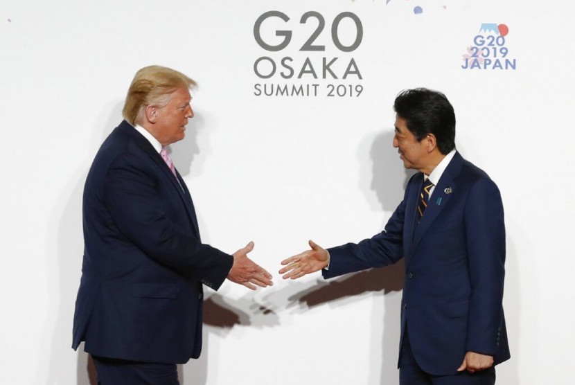 Presiden AS Donald Trump dan Perdana Menteri Jepang Shinzo Abe dalam sesi foto Konferensi Tingkat Tinggi (KTT) G-20 di Osaka, Jepang, Jumat (28/6).
