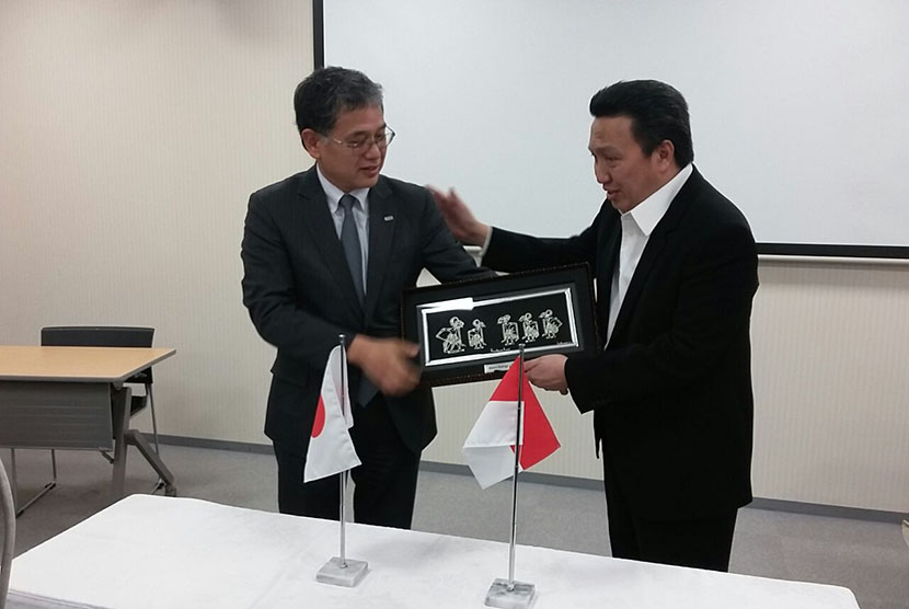   Presiden Direktur Adaro Energy, Garibaldi Thohir (kanan) menyerahkan souvenir kepada Kepala Divisi Bisnis Energi Internasional J Power, Yoshiki Onoi, di Yokohama, Jumat (11/11).