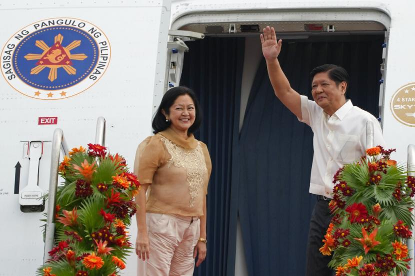 Presiden Filipina Ferdinand Marcos Jr., kanan, melambai di samping istrinya Maria Louise saat mereka menaiki pesawat menuju China pada Selasa, 3 Januari 2023, di Pangkalan Udara Villamor di Manila, Filipina.