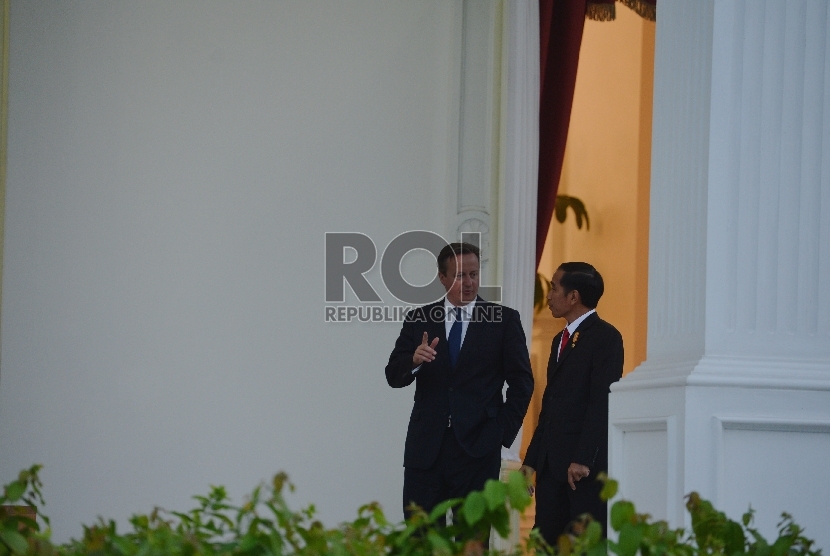 Presiden Joko Widodo (kanan) berbincang dengan Perdana Menteri Inggris David Cameron (kiri) di teras Istana Merdeka, Jakarta, Senin (27/7).