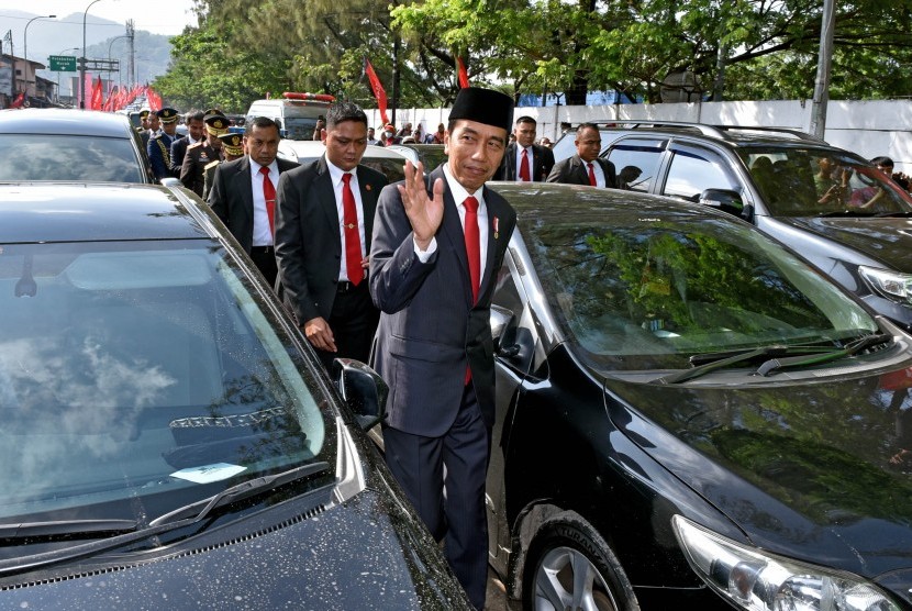 Presiden Joko Widodo (kanan) berjalan kaki di antara kendaraan yang terjebak kemacetan menuju lokasi Upacara Parade dan Defile HUT ke-72 TNI Tahun 2017 di Dermaga Indah Kiat, Cilegon, Banten Kamis (5/10). 