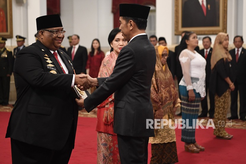 Presiden Joko Widodo (kanan) menyerahkan plakat anugerah gelar pahlawan nasional kepada ahli waris tokoh asal Sulawesi Tenggara Sultan Himayatuddin, Gubernur Sulawesi Tenggara Ali Mazi (kiri) di Istana Negara, Jakarta, Jumat (8/11/2019). 