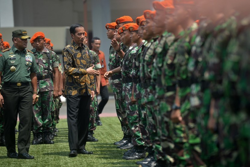 Presiden Joko Widodo (kedua kiri) didampingi Panglima TNI Jenderal TNI Gatot Nurmantyo (kiri) berjabat tangan dengan Prajurit TNI seusai memberikan arahan terkait pengamanan demonstrasi 4 November, di Jakarta, Senin (7/11).