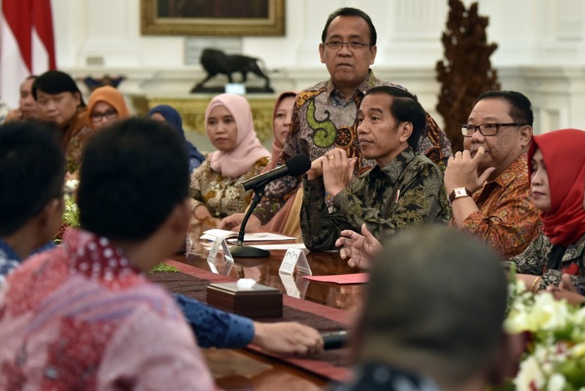 Presiden Joko Widodo (ketiga kanan) didampingi Menteri Koperasi dan UMKM Anak Agung Gede Ngurah Puspayoga (kedua kanan) dan Mensesneg Pratikno berdialog dengan pelaku UMKM di Istana Merdeka, Jakarta, Jumat (25/11).