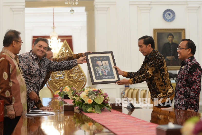 Presiden Joko Widodo menerima kenang-kenangan dari Pemilik Plug and PlaySaeed Amidi saat diterima di Istana Merdeka, Jakarta, Selasa (15/11).