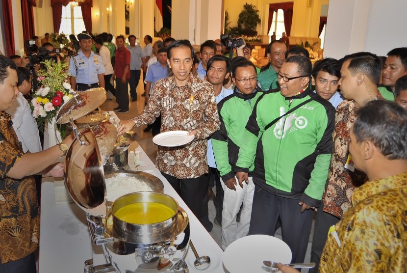 Presiden Joko Widodo (tengah) berdialog dengan pengendara Gojek saat pertemuan makan siang bersama pengemudi kendaraan umum di Istana Negara, Jakarta, Selasa (2/9).