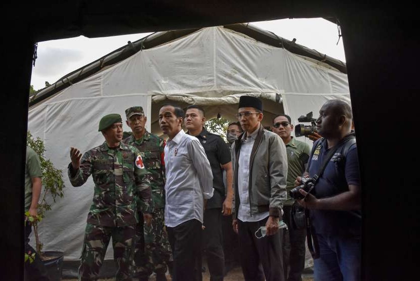 Presiden Joko Widodo (tengah) didampingi Gubernur NTB TGB Zainul Majdi (kedua kanan) meninjau kondisi rumah sakit lapangan di Tanjung, Lombok Utara, NTB, Senin (13/8). 