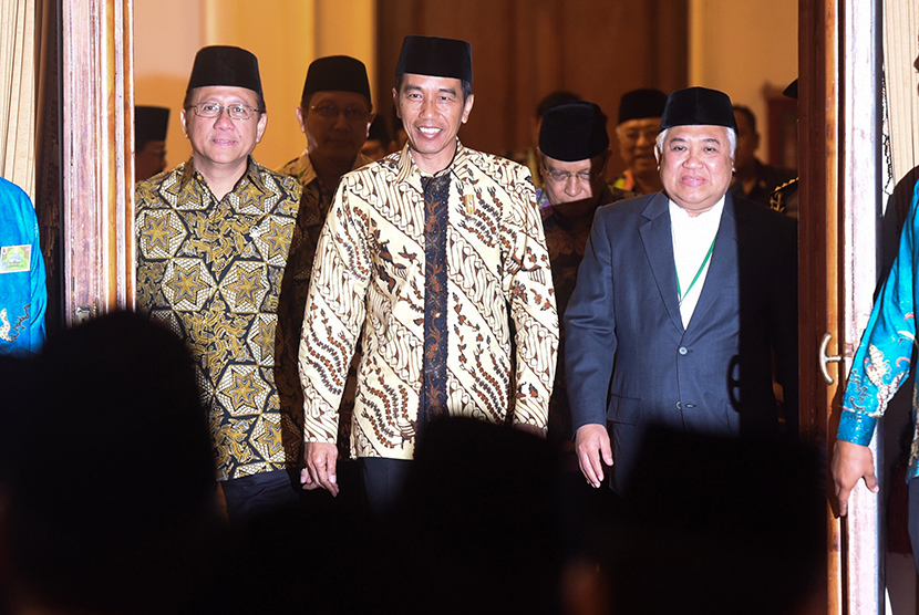 Presiden Joko Widodo (tengah) didampingi Ketua MUI Din Syamsuddin (kedua kanan), Ketua DPD Irman Gusman (kedua kiri) memasuki area pembukaaan Munas MUI ke-9 di Grahadi, Surabaya, Jawa Timur, Selasa (25/8).  (Antara/Zabur Karuru)