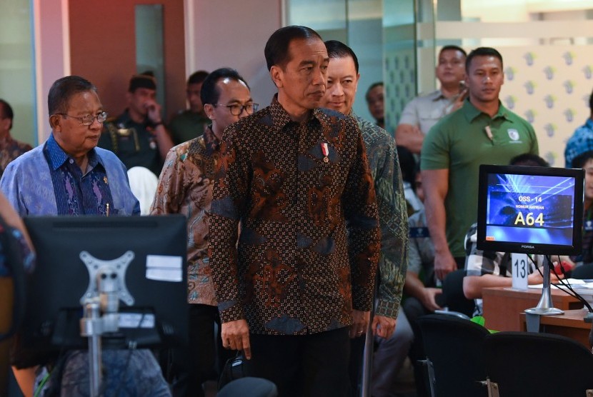 Presiden Joko Widodo (tengah) didampingi Menko Perekonomian Darmin Nasution (kiri) dan Kepala BKPM Thomas Lembong (kedua kanan) meninjau layanan konsultasi Online Single Submission (OSS) BKPM di PTSP BKPM Jakarta, Senin (14/1/2019). 