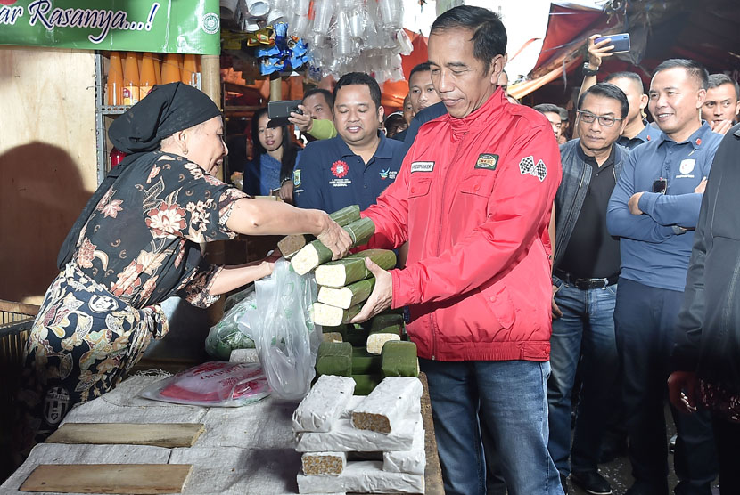 President Joko Widodo (center) buys tempe when visiting traditional market Pasar Anyar, Tangerang, Banten, Sunday (Nov 4).