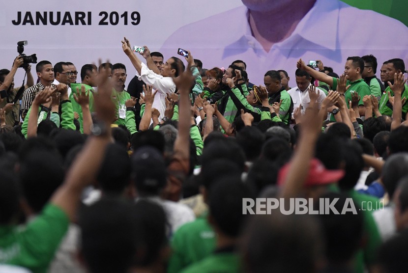 Presiden Joko Widodo (tengah) mengajak para pengemudi online berswafoto usai menghadiri Silatnas Keluarga Besar Pengemudi Online di Jakarta, Sabtu (12/1/2019). 