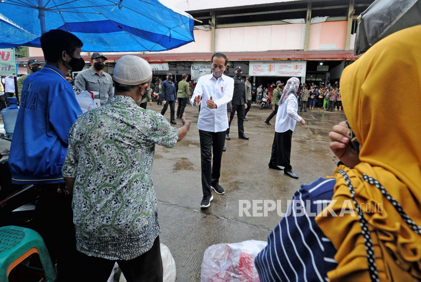 Presiden Joko Widodo (tengah) menyambut jabat tangan dari seorang pedagang saat kunjungan kerja ke Pasar Modern Angso Duo di Jambi, Kamis (7/4/2022). Dalam kunjungannya ke pasar terbesar di Jambi itu, Presiden Joko Widodo juga menyerahkan bantuan modal kerja dan Bantuan Langsung Tunai (BLT) minyak goreng untuk sejumlah pedagang dan keluarga penerima manfaat. 