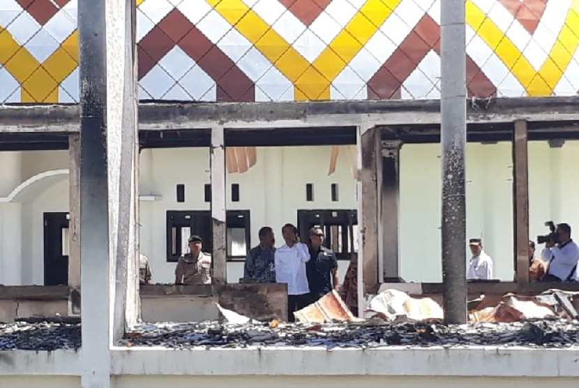 Presiden Jokowi dan sejumlah menteri Kabinet Indonesia Maju meninjau sejumlah lokasi dampak kerusuhan di Wamena, di antaranya di kantor Bupati Jayawijaya dan juga Pasar Wouma, Senin (28/10). Tampak puing-puing bekas kerusuhan masih terlihat berserakan di lokasi sekitar. 