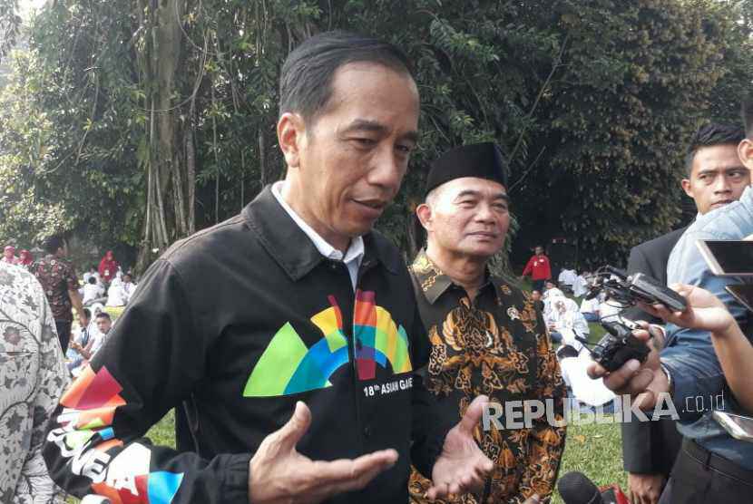 Presiden Jokowi menggunakan jaket bertuliskan Asian Games di bagian belakang