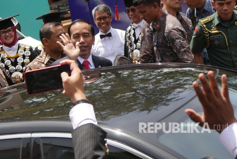 Presiden RI Joko Widodo (Jokowi) melambaikan tangan usai hadir menyampaikan orasi ilmiah pada puncak perayaan Dies Natalis ke-60 Unversitas Padjadjaran (Unpad), di Graha Sanusi Hardjadinata, Kampus Unpad, Kota Bandung, Senin (11/9). 