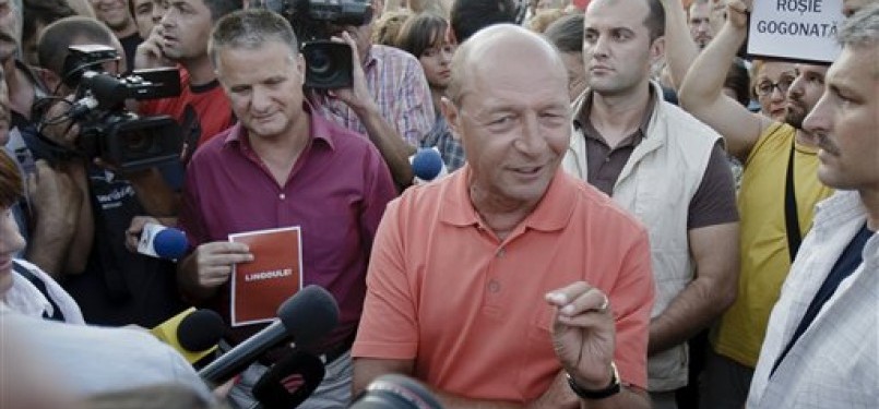 Presiden Rumania, Traian Basescu (tengah berkaos), saat diwawancarai media.