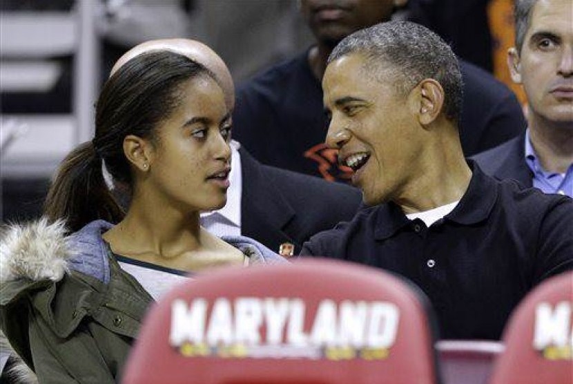 President Barack Obama as he chats with daughter Malia (file photo)