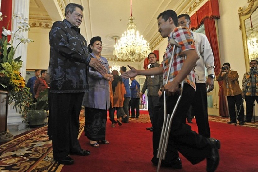 President Susilo Bambang Yudhoyono (left) shakes hand with a guess in an open house to celebrate Eid al Fitr at the presidential palace in Jakarta on Thursday, August 8, 2013.