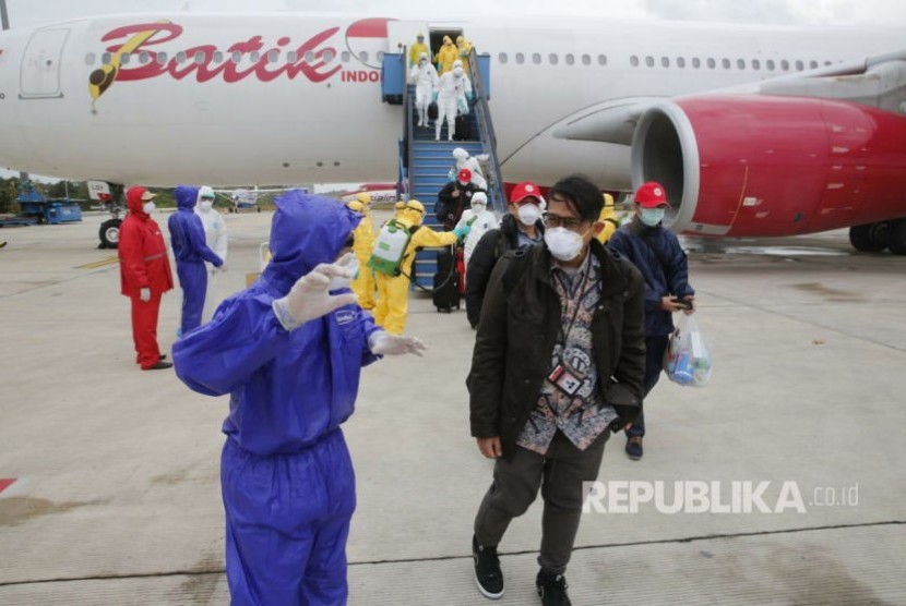 Proses evakuasi WNI dari Wuhan, Hubei China sesaat setelah turun dari pesawat Boeing A330-300 Batik Air di Bandara Internasional Hang Nadim Batam, Ahad (2/2). Masih ada tujuh WNI yang terpaksa bertahan di Hubei.